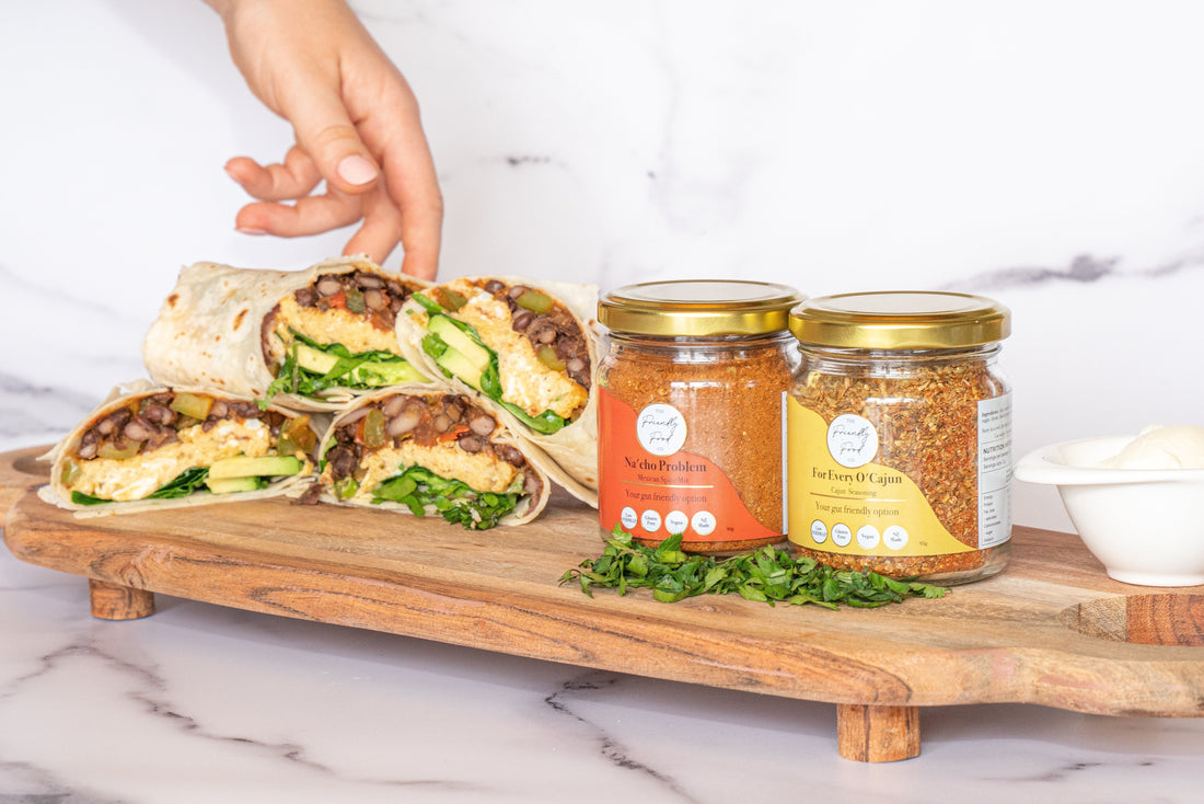 The Friendly Food Co Mexican and Cajun Seasonings with Vegetarian Breakfast Burrito on a chopping board
