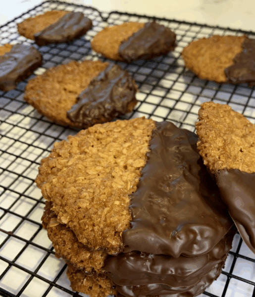 Cookies with chocolate coating on a cooling rack