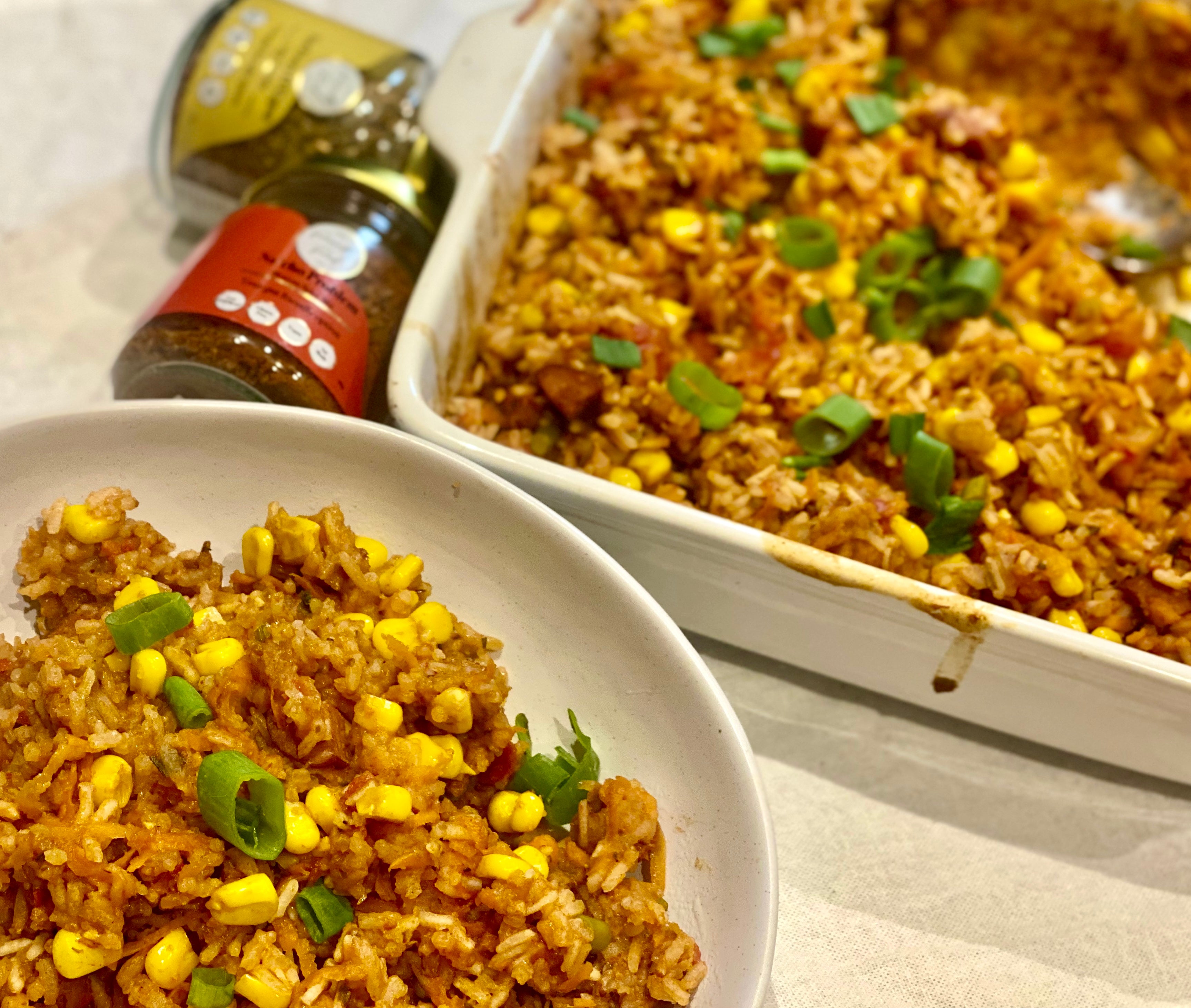 Low FODMAP Chorizo Mexican Baked Rice in a white dish, featureing The Friendly Food Co. Mexican and Cajun seasoning