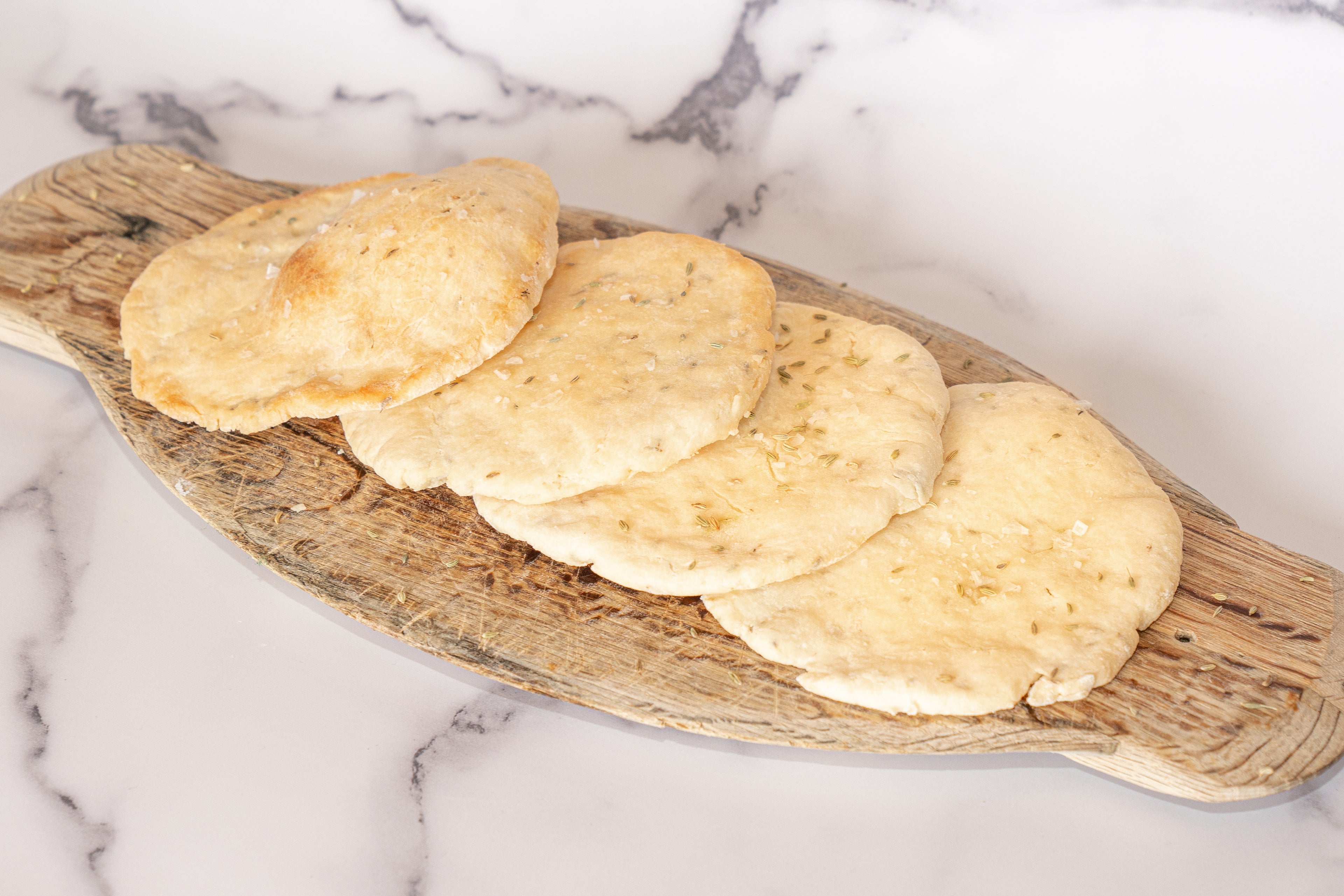 Two Ingredient Gluten Free, Low FODMAP Flatbread on a wooden board with a marble background